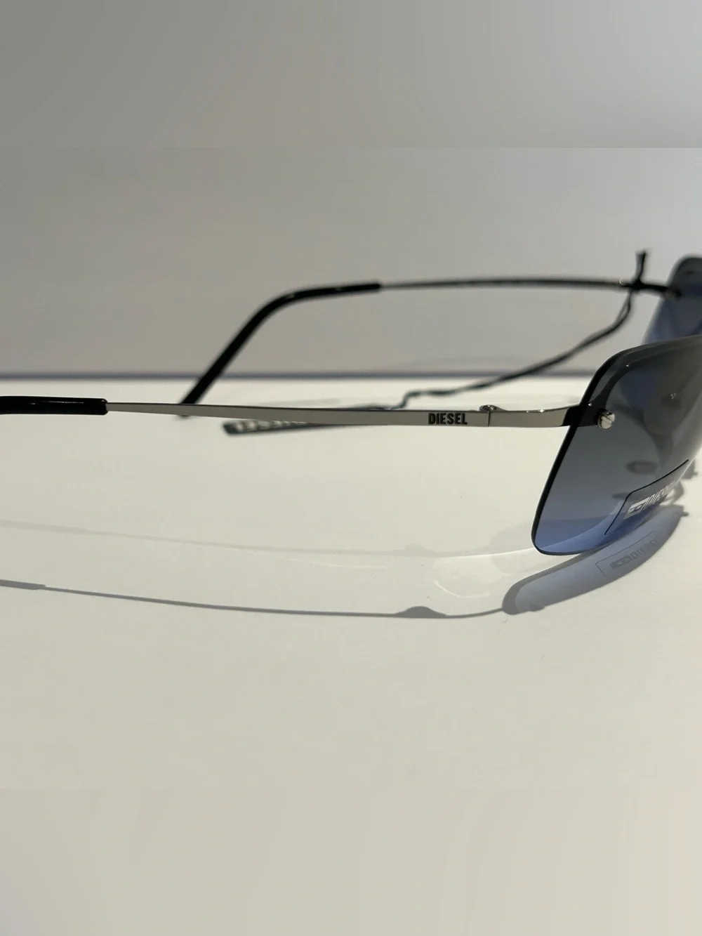 Diesel Gunmetal Frame Blue Gradient Lens Rimless Sunglasses -Kusini